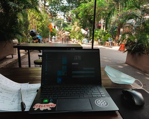 A neat coworking desk in Medellin with soft ambient lighting and no screen glare